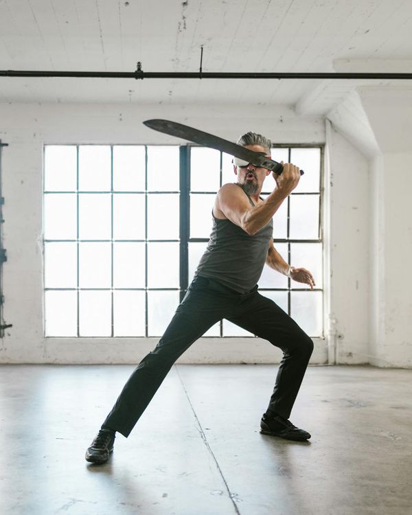 Man in a powerful stance, demonstrating physical control and balance.
