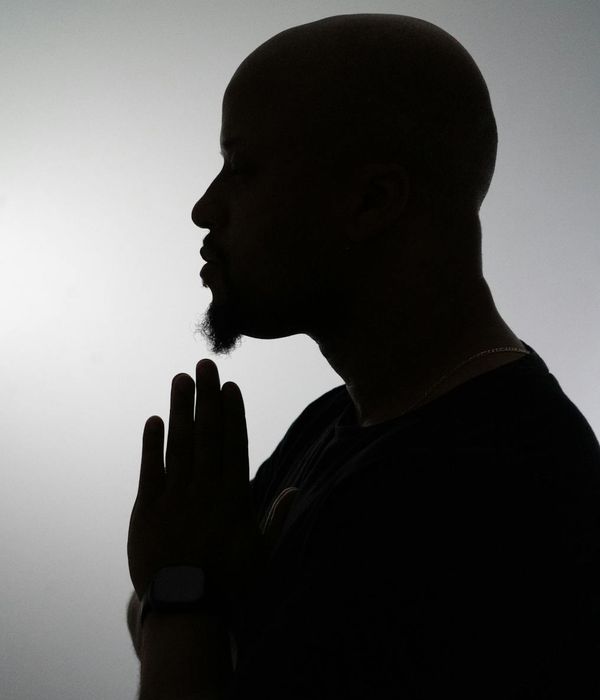 Silhouette of a man in a meditative pose, symbolizing inner peace and focus.